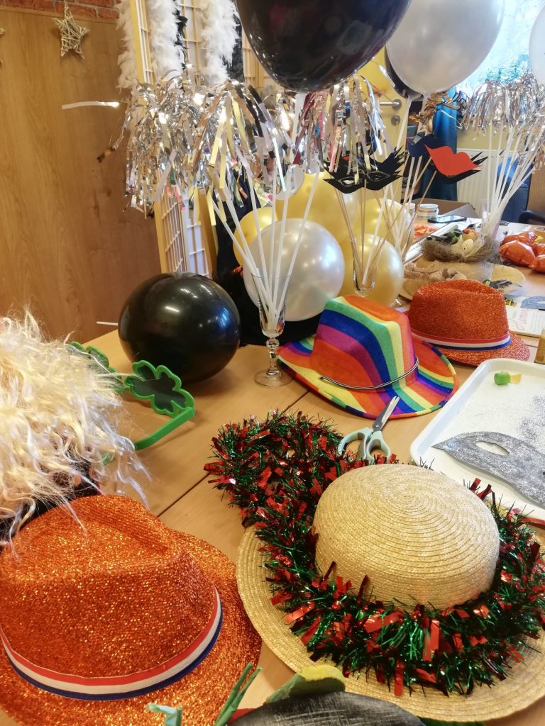 Na stole leżą noworoczne ozdoby: kapelusze