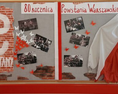 Zbliżenie. Tablica, polska flaga, symbol Polski Walczącej. Zdjęcia żołnierzy. Napis